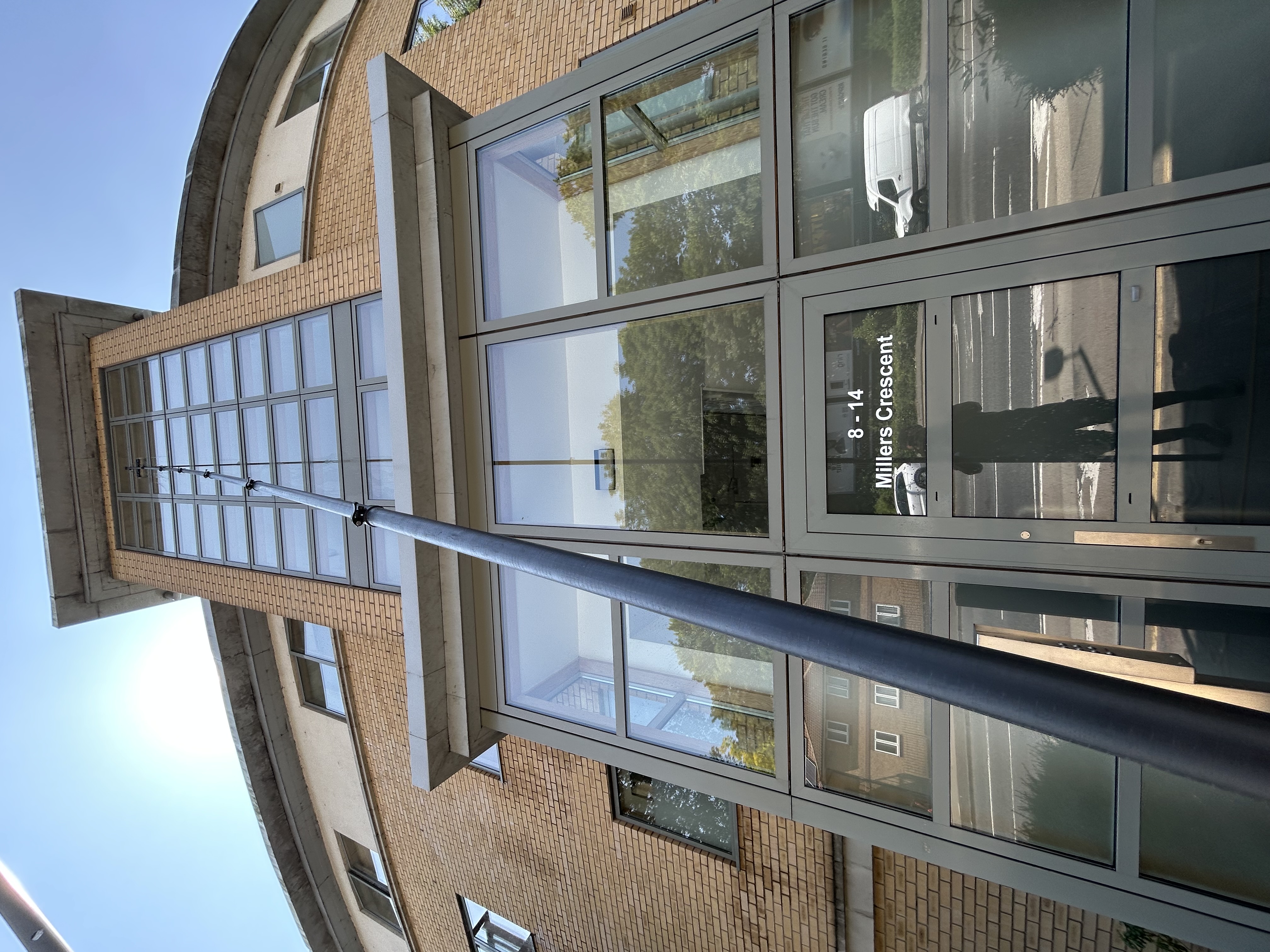 Commercial window cleaning with reach-and-wash system